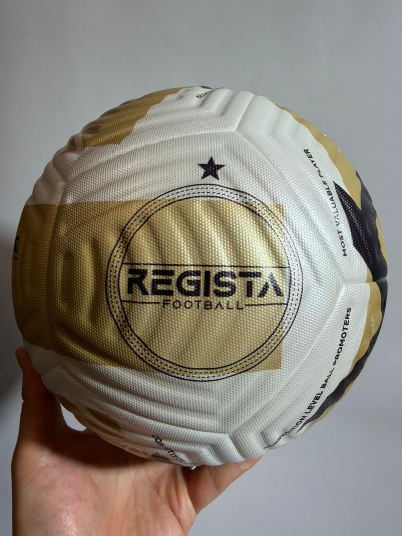 The Regista Q1 Match Ball, white and gold with a circular Regista Football roundel on the front panel.
